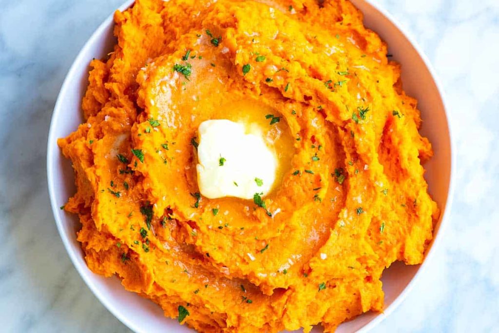 A creamy bowl of mashed sweet potatoes.